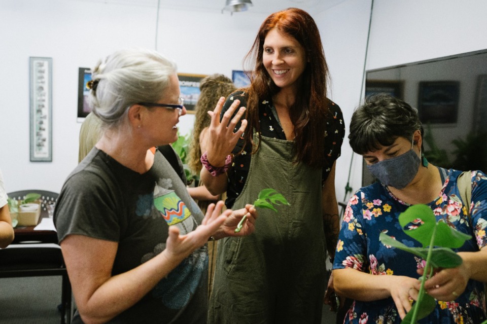 <strong>Jennifer Hardesty (left) and Amanda Yarbro-Dill (center), the organizer, and Ozge Kovarik (right) chat about a Monstera propagation Saturday July 2nd, 2022.</strong> (Lucy Garrett/Special to The Daily Memphian)