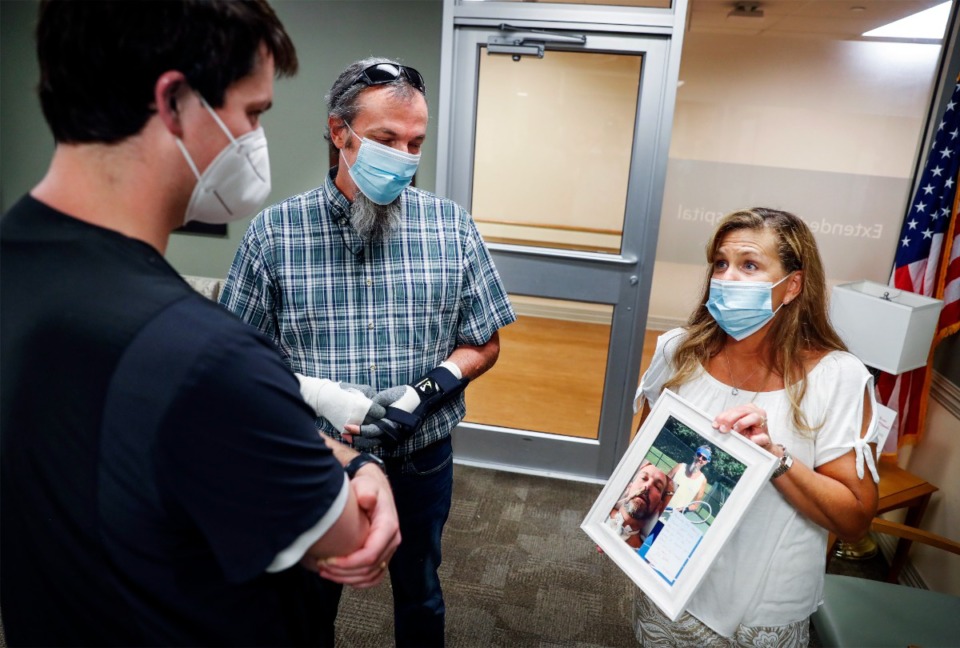 <strong>John Butler (middle) and his wife Tracey (right) thank Regional One Health personnel on Thursday, July 28, 2022. When Butler was admitted to Regional One last year, he had a 3% chance of survival after contracting COVID.</strong> (Mark Weber/The Daily Memphian)