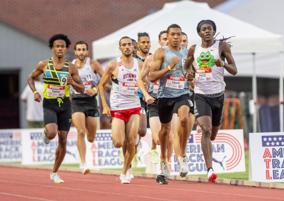 <strong>Former Whitehaven High School runner Terrick Johnson (right, white shirt) sets the pace for the men's pro 800-meter race at the Ed Murphey Classic at the University of Memphis South Campus, Friday, July 29, 2022.&nbsp;</strong>(Greg Campbell/Special to The Daily Memphian)