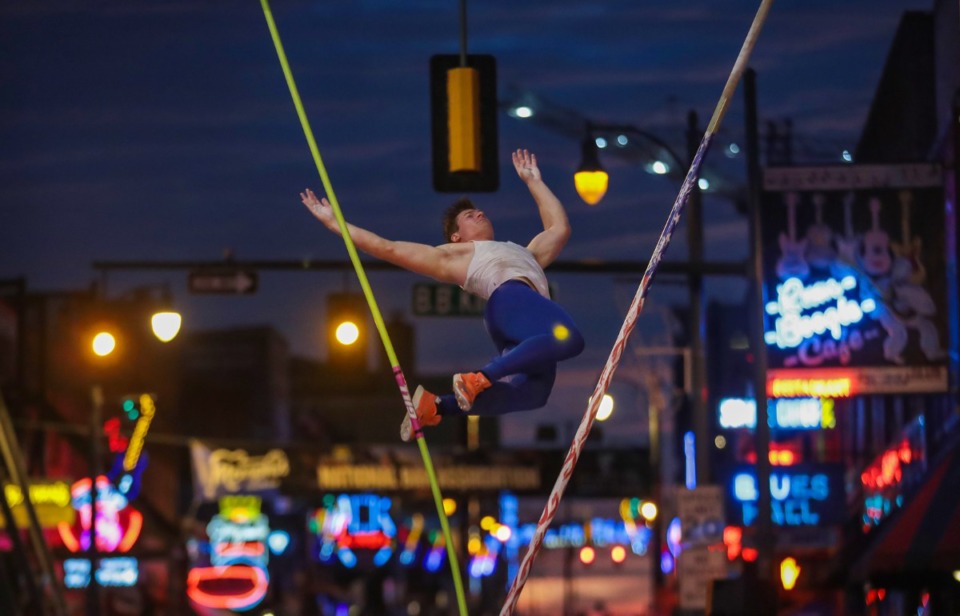 <strong>Matt Ludwig tumbles to the ground during the pole vault portion of the Ed Murphey Classic on Beale Street, July 30, 2022. Ludwig won the men&rsquo;s competition by clearing a height of&nbsp;18 feet 8.75 inches.</strong> (Patrick Lantrip/Daily Memphian)