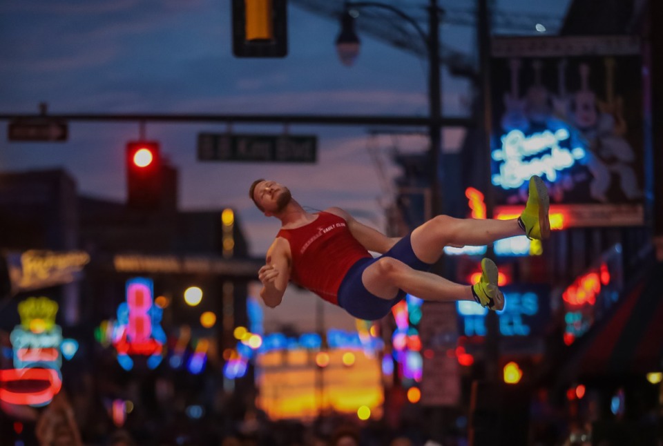 <strong>Deakin Volz falls to the mat during the pole vault portion of the Ed Murphey Classic on Beale Street, July 30, 2022.</strong> (Patrick Lantrip/Daily Memphian)