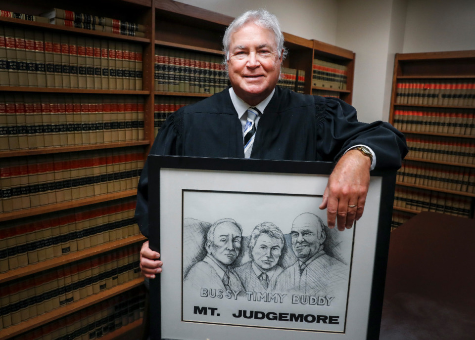 <strong>Drug Court Judge Tim Dwyer hold a print of himself and his uncles Buddy Dwyer and Judge Robert Dwyer on Thursday, July 28, 2022. After 38 years, Judge Dwyer will be retiring from the bench at the end of August.</strong> (Mark Weber/The Daily Memphian)