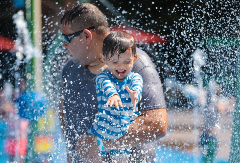 <strong>Zander Marquez plays in the water with his dad, Alberto, at the Memphis Zoo's new Splash Park on Saturday, July 16.</strong>&nbsp;<strong>Memphians likely are looking for other ways to beat the heat; this summer is the hottest on record for Memphis.</strong> (Patrick Lantrip/Daily Memphian)