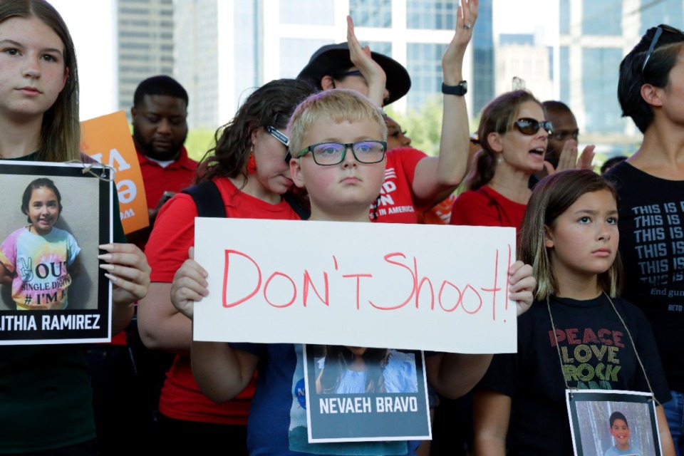 <strong>Children hold signs and photos of the Uvalde, Texas school shooting victims during a rally at Discovery Green Park, across the street from the National Rifle Association Annual Meeting held at the George R. Brown Convention Center Friday, May 27, 2022, in Houston.</strong> (AP Photo/Michael Wyke)