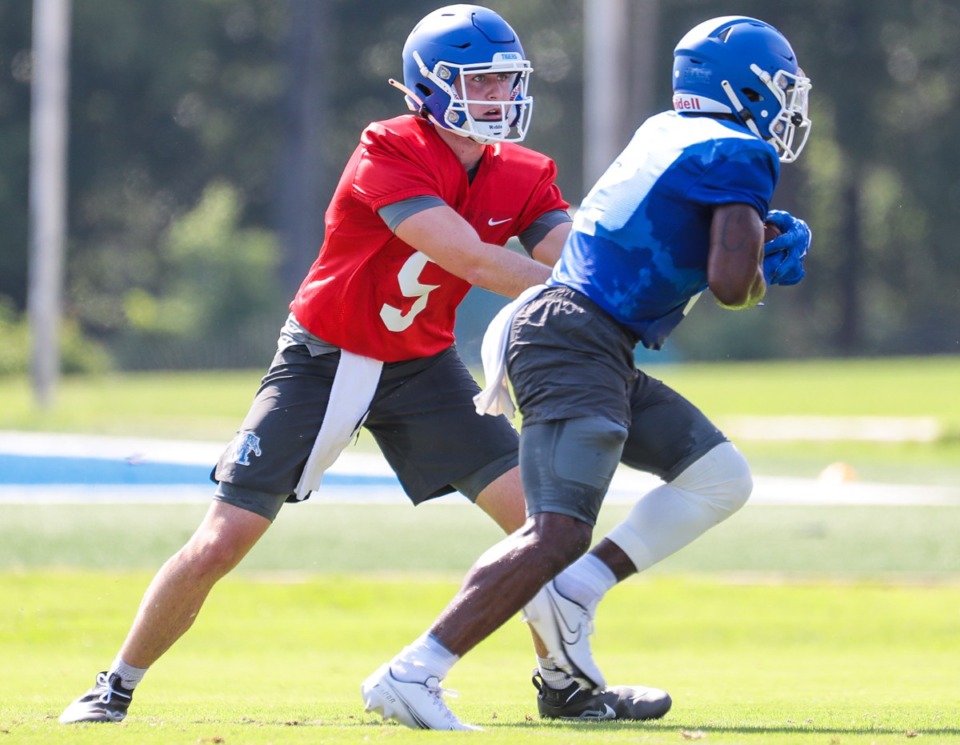 <strong>University of Memphis quarterback Seth Henigan (5) hands the ball off on the first day of training, Aug. 3, 2022.</strong> (Patrick Lantrip/Daily Memphian)