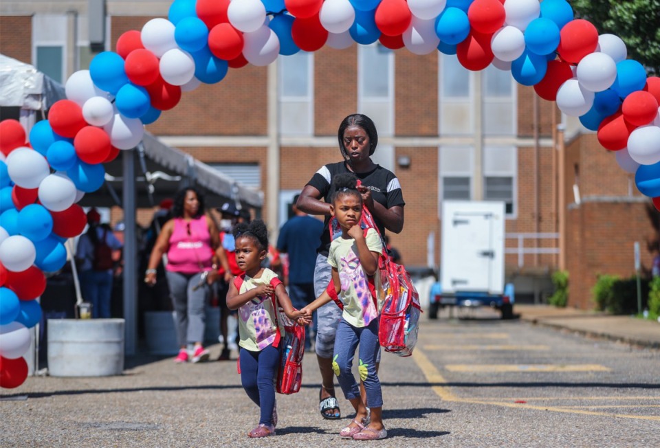 <strong>Markesha Durham walks with her children, Kyeona Woods and Enaniya Wade, at the Memphis-Shelby County Schools back-to-school weekend festival.&nbsp;The new MSCS school year starts Monday, Aug. 8.</strong> (Patrick Lantrip/The Daily Memphian)