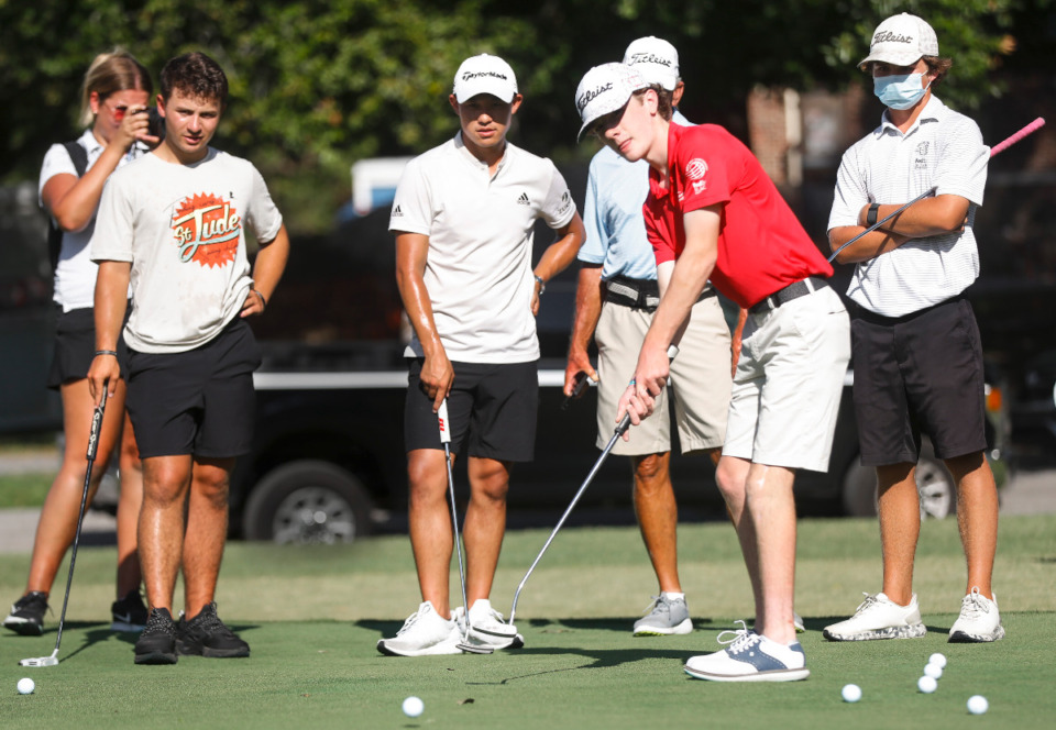 <strong>St. Jude Children&rsquo;s Research Hospital patient Bailey Jessop (middle) hits a putt during an event with PGA golfer Collin Morikawa on Monday, Aug. 8, 2022, at Overton Park. </strong>(Mark Weber/The Daily Memphian)