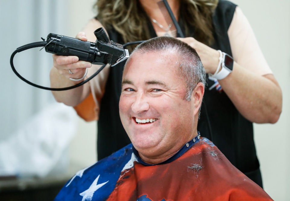 <strong>Arlington Mayor Mike Wissman receives a buzz cut after betting the voter turnout for the municipal election would fall under 30%.</strong> (Mark Weber/The Daily Memphian)