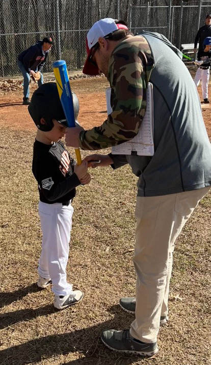 <strong>Will Drennan (teaching Jack Young how to bat) was a baseball coach, too.</strong> (Courtesy Matt Young)