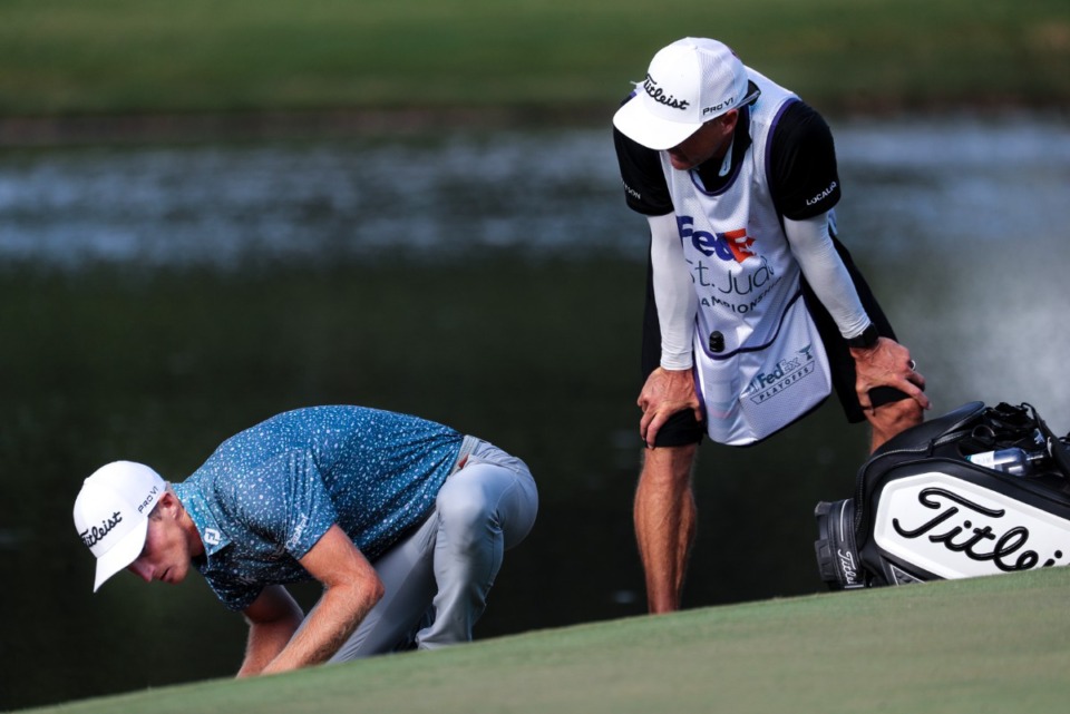 <strong>Will Zalatoris and his caddy look at his ball on the 11th hole during the playoffs for the title at the FedEx St. Jude Championship at TPC Southwind Aug. 14, 2022.</strong> (Patrick Lantrip/Daily Memphian)