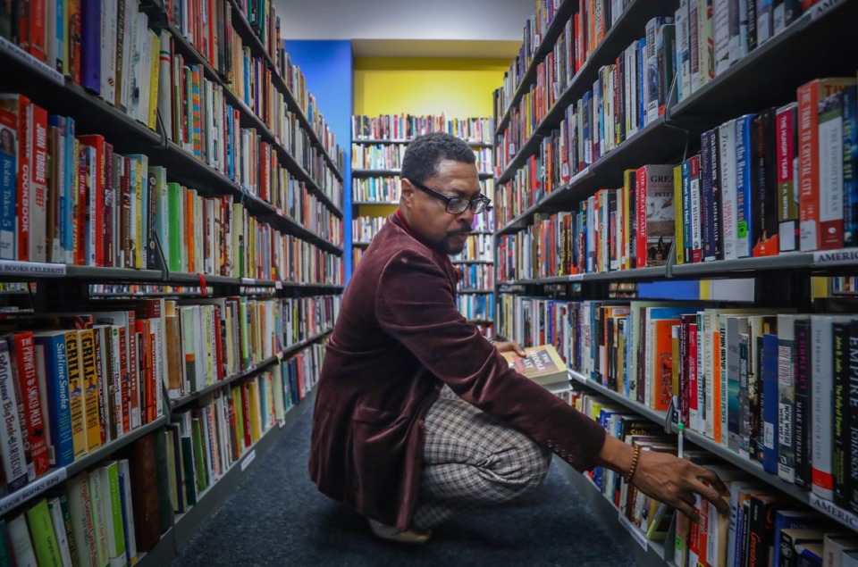 <strong>Antonio Quinn inspects the shelves of the Second Editions Book Store inside the Benjamin L. Hooks Library. The nonprofit Friends of the Library organizations raises&nbsp;over $400,000 annually for library operations.</strong> (Patrick Lantrip/Daily Memphian)