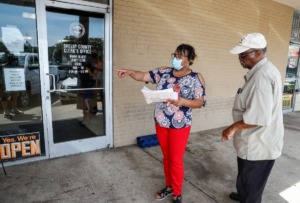 <strong>A Shelby County Clerk employee (left) helps a resident during the first day of the no-wait, no-line policy at county clerks' offices on Tuesday, July 26, 2022 in Whitehaven</strong>. (Mark Weber/Daily Memphian file)