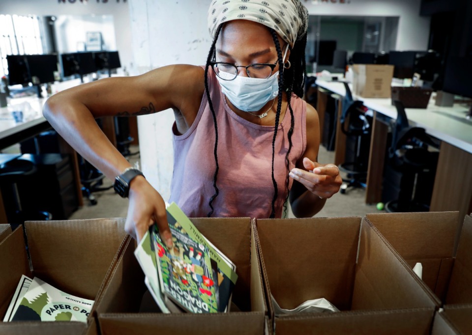 <strong>Shelby Smith places books into summer reading kits on Thursday, May 21, 2020.</strong> (Mark Weber/Daily Memphian file)