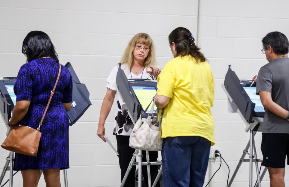<strong>A poll worker helps voters cast their ballots on Election Day, Thursday, Aug. 4, in Arlington.</strong> (Mark Weber/The Daily Memphian)