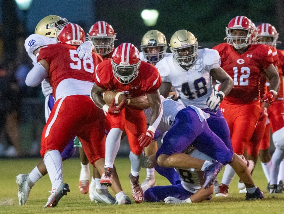 <strong>Germantown's BJ Blake fights the defensive line of CBHS to make a first down in the second quarter of their game at Germantown High School, Saturday, Aug. 20, 2022.</strong> (Greg Campbell/Special to The Daily Memphian)