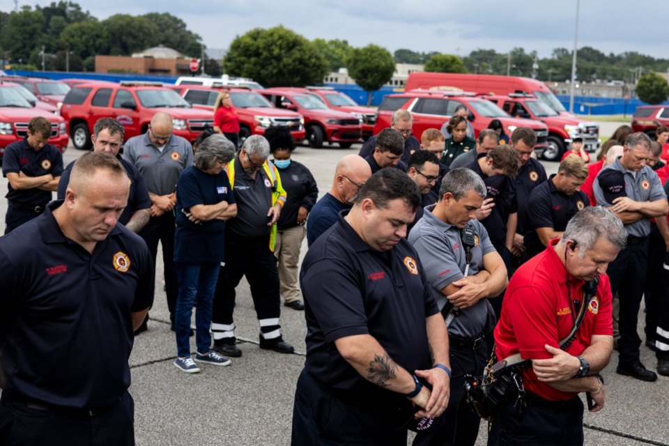<strong>Firefighters pray before the start of the Memphis Fire Department&rsquo;s Sea of Red event honoring firefighter David Pleasant on Sunday evening.</strong> (Brad Vest/Special to The Daily Memphian)