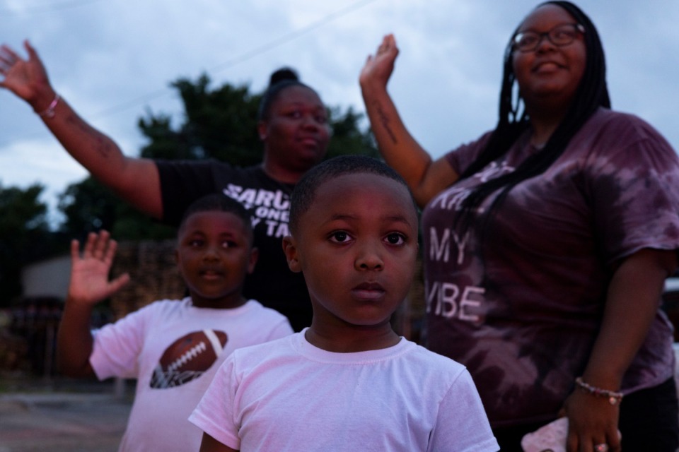 <strong>From left: Ladarius Shipp, 5; Cebrena Nelson; Carrion Cunningham, 5, and Cierra Davis stopped to show their support during the Memphis Fire Department&rsquo;s procession.</strong> (Brad Vest/Special to The Daily Memphian)