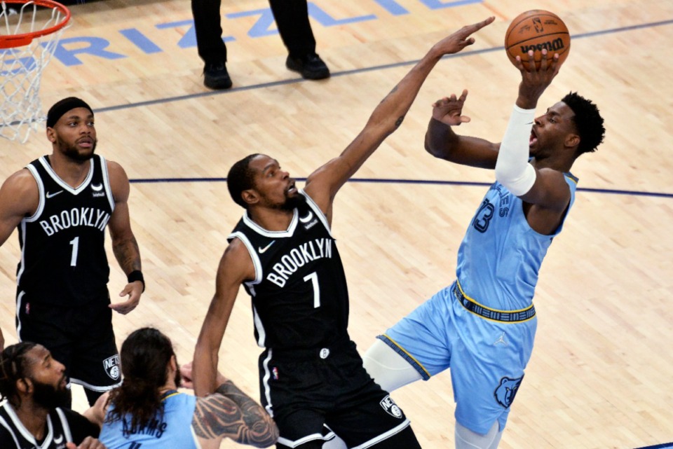 <strong>Memphis Grizzlies forward Jaren Jackson Jr. (13) shoots against Brooklyn Nets forward Kevin Durant (7) during a March 2022 game in Memphis.</strong> (AP file photo/Brandon Dill)