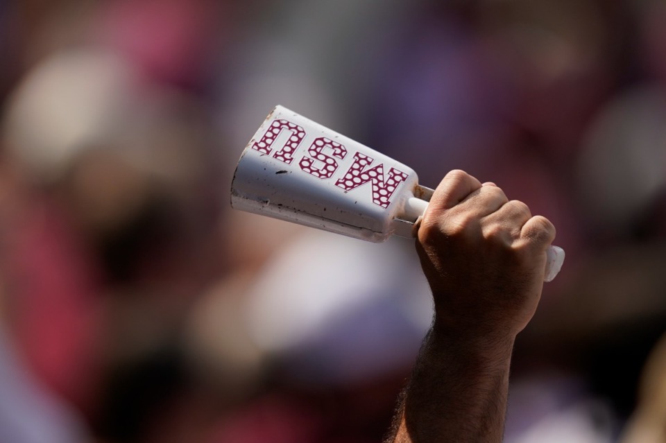 <strong>A Mississippi State fan rings a logo covered cowbell during an NCAA college baseball super regional game against Notre Dame, Saturday, June 12, 2021, in Starkville, Miss. Mississippi State won 9-8.</strong> (AP Photo/Rogelio V. Solis)