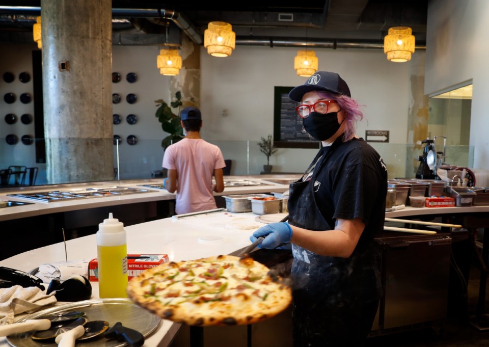<strong>A Trasimeno&rsquo;s pizza maker pulls a pizza out of a wood fire oven in June 2021.&nbsp;The lunch specials are available Tuesday-Thursday, from 11:30 a.m. to 3 p.m.</strong> (Mark Weber/The Daily Memphian file)