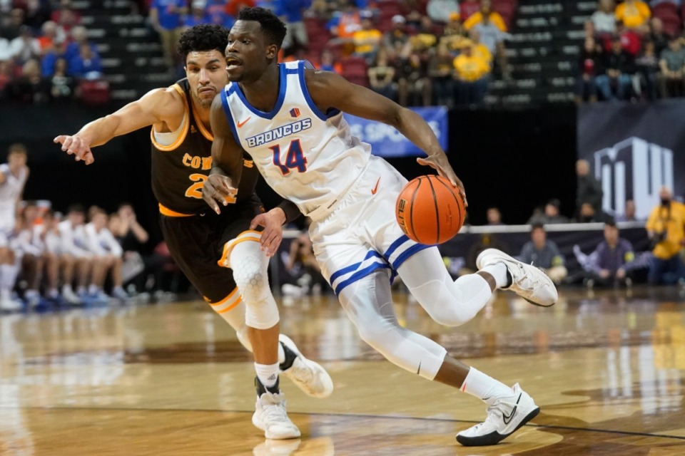 <strong>Boise State guard Emmanuel Akot (14) drives as Wyoming guard Hunter Maldonado (24) defends during the first half of an NCAA college basketball game Friday, March 11, 2022, in Las Vegas. Akot, a recent recruit for the Memphis Tigers, enrolled at Western Kentucky University on Monday.</strong> (AP Photo/Rick Bowmer)