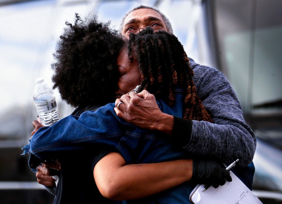 <strong>Homicide detective Vikki Shabazz (left) comforts the parents of rapper Young Dolph after he was killed outside of Makeda's Homemade Butter Cookies, Nov. 17, 2021.</strong> (Patrick Lantrip/The Daily Memphian)