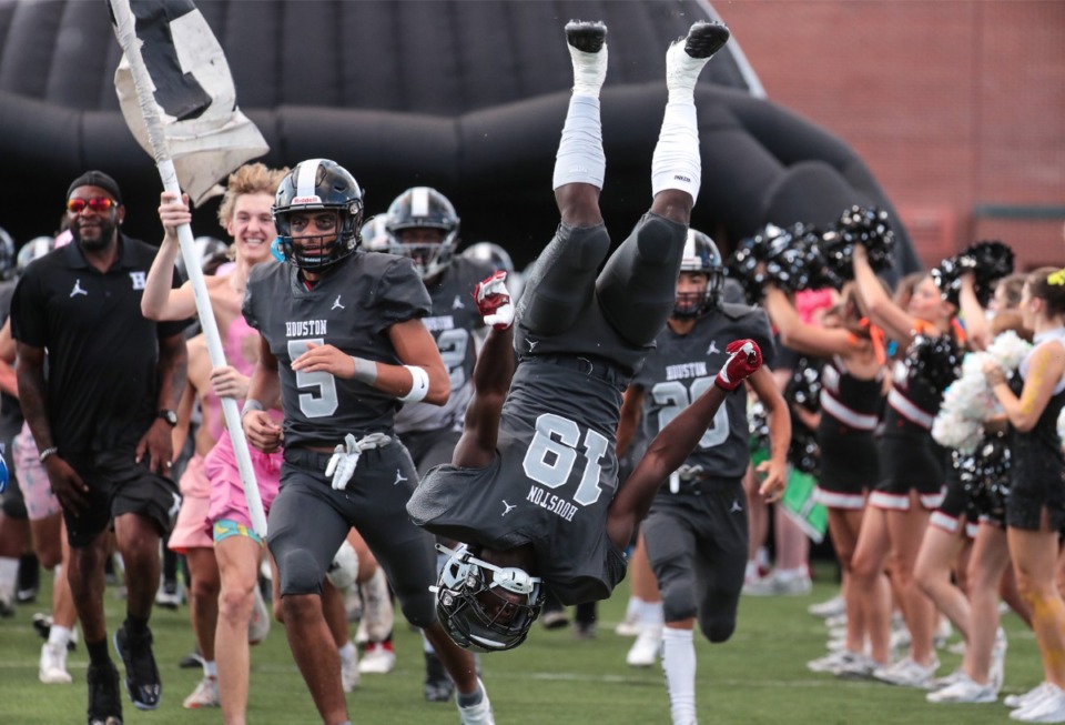 <strong>Houston receiver Ledeadrick James (19) does a flip as his team takes the field against Briarcrest on Aug. 26, 2022, a big night for prep football.</strong> (Patrick Lantrip/Daily Memphian)