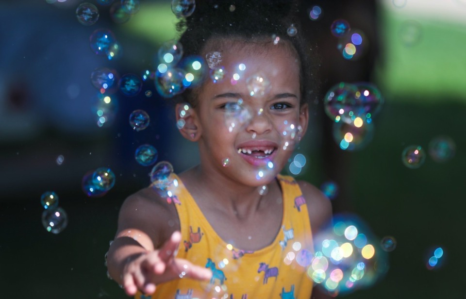 <strong>Zoe Taylor plays with bubbles at the Ruby Bridges Reading Festival held at the The National Civil Rights Museum Aug. 27, 2022.</strong> (Patrick Lantrip/Daily Memphian)