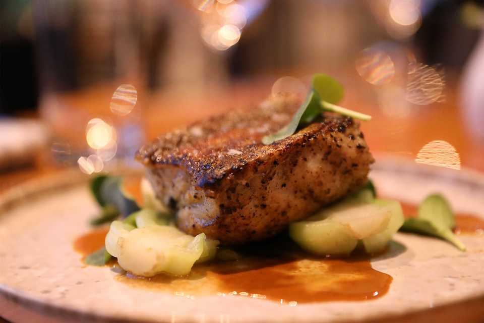 <strong>Hard-seared black bass with lightly-seared baby bok choy, and a red miso curry sauce with coconut milk and butter.</strong> (Patrick Lantrip/Daily Memphian)