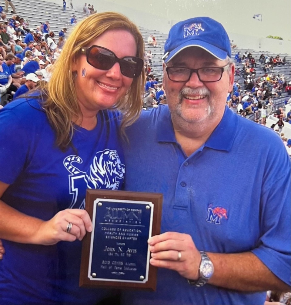 <strong>John Avis and his daughter, Ashli, display his plaque from when Avis was inducted into the College of Education Health and Human Sciences Alumni Hall of Fame. Avis&nbsp;was honored with the plaque during half-time of a Tigers football game on the field.&nbsp;</strong>(Submitted)