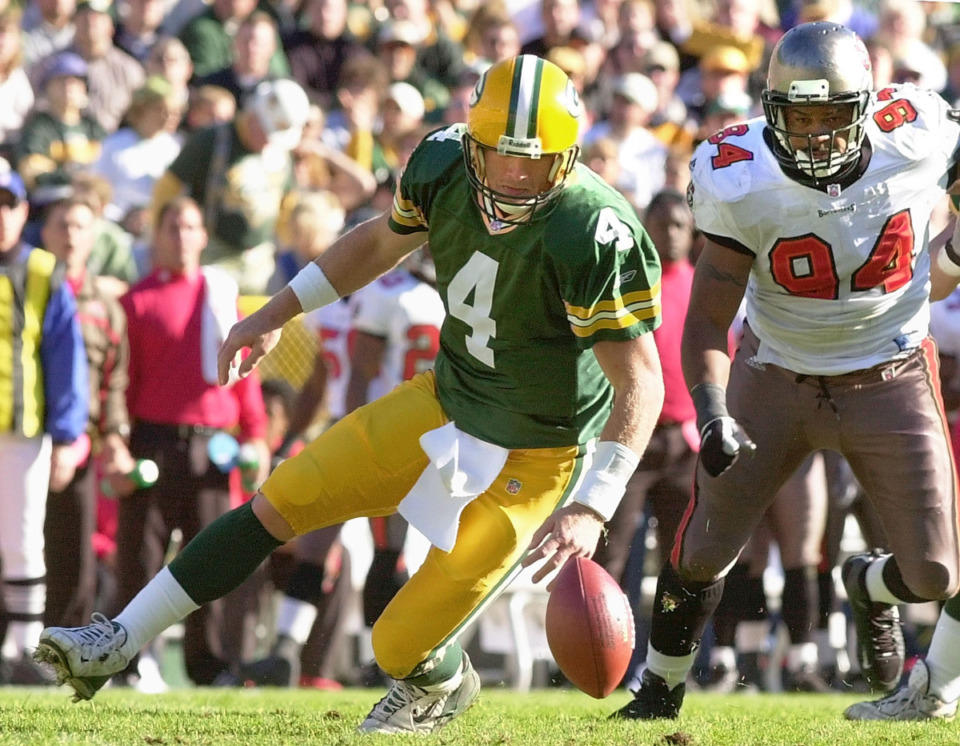 <strong>Green Bay Packers quarterback Brett Favre (4) and Tampa Bay Buccaneers defensive end Steve White (94) go after a fumble in the first half Sunday, Nov. 4, 2001, in Green Bay, Wis. Favre recovered the ball.</strong> (AP File Photo/Mike Roemer)