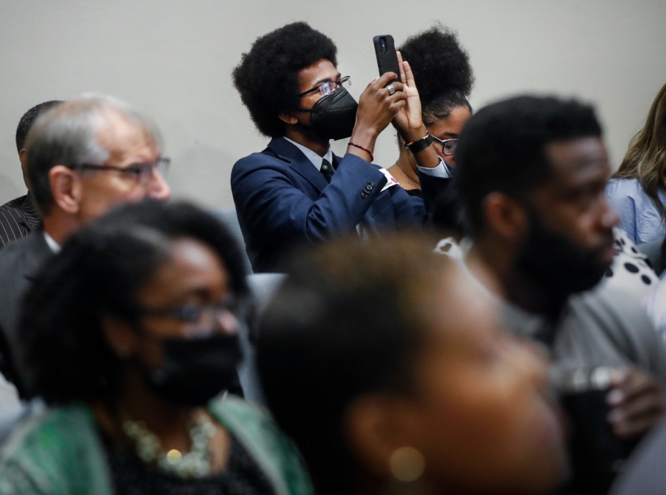 <strong>Justin J. Pearson of Memphis Community Against Pollution (holding phone) and other public commenters at a Memphis Light, Gas and Water board meeting on Thursday, Sept. 1, said his group can&rsquo;t confidently endorse any recommendation yet.</strong> (Mark Weber/The Daily Memphian)