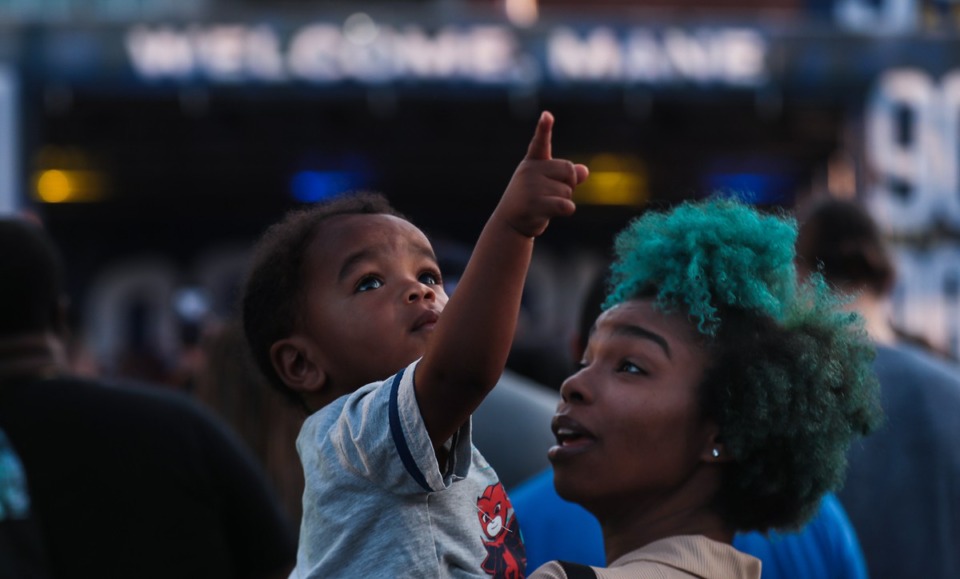 <strong>Kendrixx Allen points out a drone to his mother, Kailein Dixon, during the 901 Day Grizz Bash held outside of FedExForum on Sept. 1, 2022.</strong> (Patrick Lantrip/Daily Memphian)