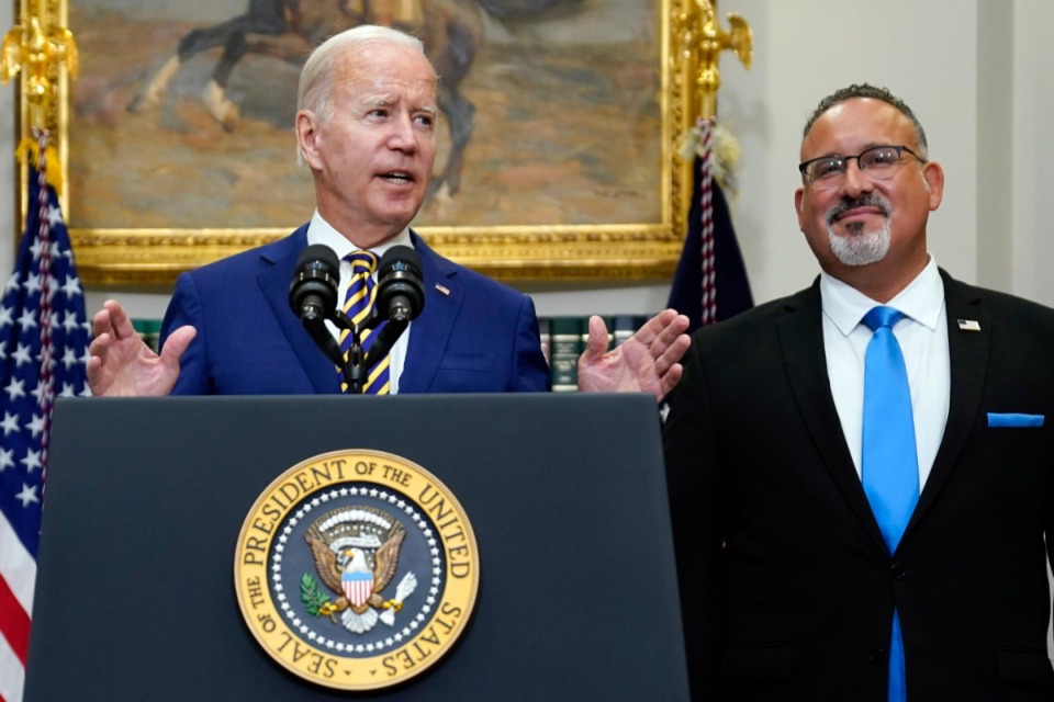 <strong>President Joe Biden speaks about student loan debt forgiveness in the Roosevelt Room of the White House, Aug. 24, 2022, in Washington. Education Secretary Miguel Cardona listens at right.</strong>&nbsp;(AP Photo/Evan Vucci, File)