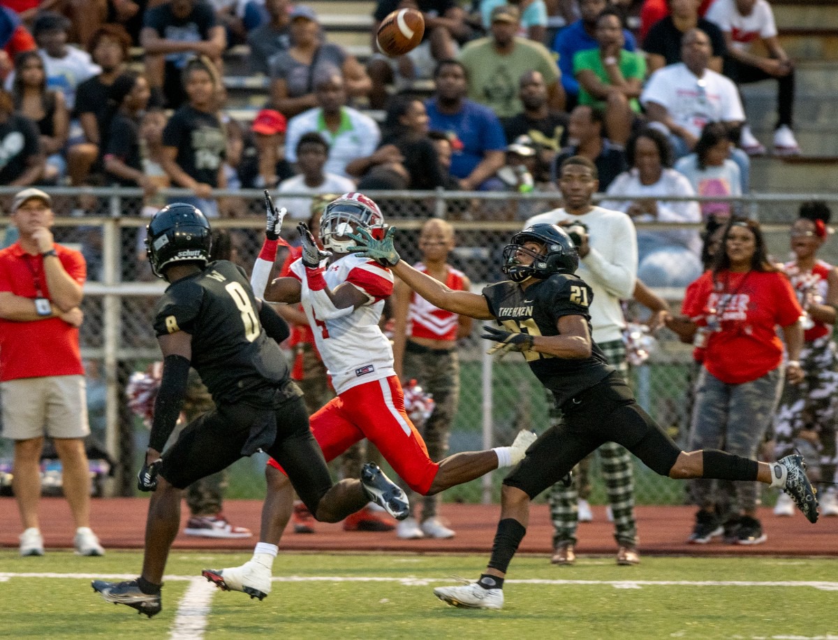 <strong>Germantown wide receiver Kyrrae Franklin makes a key reception with double coverage from Whitehaven's Damrio Smith and Ziggy Short at Whitehaven High School on Friday, Sept. 2, 2022.</strong> (Greg Campbell/Special to The Daily Memphian)