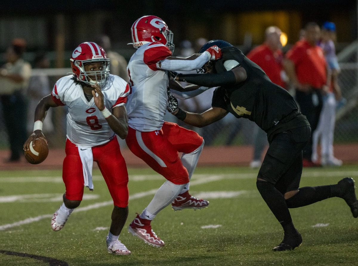 <strong>Germantown quarterback Isaiah Tate escapes a sack while running back BJ Blake blocks Whitehaven linebacker DJ Areje at Whitehaven High School on Friday, Sept. 2, 2022.</strong> (Greg Campbell/Special to The Daily Memphian)