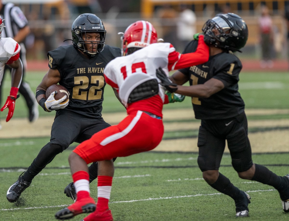 <strong>Whitehaven's Marion Bernard blocks Germantown's Elizjah Salat to help Whitehaven's Ahmad Miller gain extra yardage at Whitehaven High School on Friday, Sept. 2, 2022.</strong> (Greg Campbell/Special to The Daily Memphian)