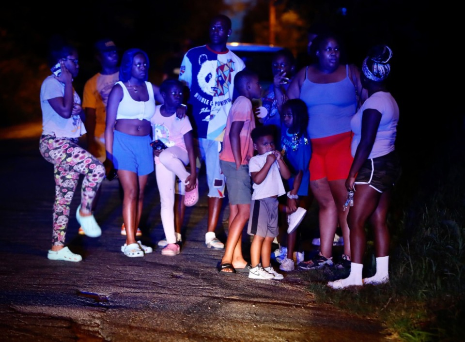 <strong>Onlookers in South Memphis near Victor Street and East Person Avenue, where a body was discovered Monday, Sept. 5. </strong>(Mark Weber/The Daily Memphian)
