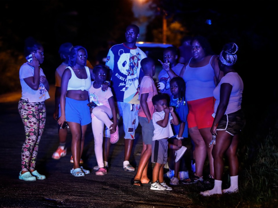 <strong>Onlookers in South Memphis near Victor Street and East Person Avenue, where a body was discovered Monday, Sept. 5, 2022.</strong> (Mark Weber/The Daily Memphian)