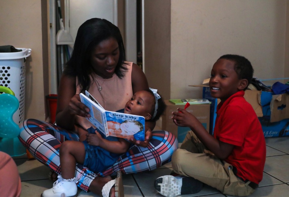 <strong>Jackie Johnson, a 23-year-old mother of two, reads to her children, Cordale, 4, and Markel, 1, before school.</strong> (Patrick Lantrip/The Daily Memphian)