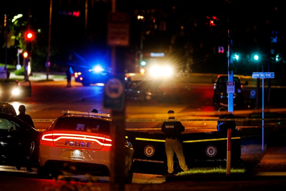 <strong>Memphis Police officers search the scene of an apparent carjacking at Poplar Avenue and Hawthorne Street on Sept. 7, 2022.</strong> (Mark Weber/The Daily Memphian)