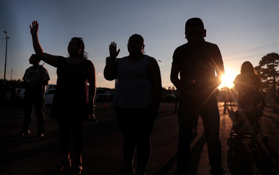 <strong>Dozens of mourners pray on Sept. 8 in the parking lot of the&nbsp;AutoZone at 4011 Jackson Ave., which was one of several crime scenes left in the wake of a shooting spree the day before.</strong> (Patrick Lantrip/Daily Memphian)