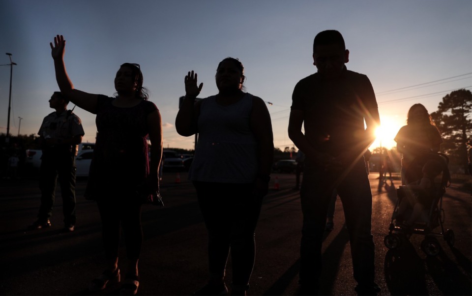 <strong>Dozens of mourners pray in the parking lot of an AutoZone, which was one of several crime scenes left in the wake of a shooting spree Wednesday, Sept. 8, 2022.</strong> (Patrick Lantrip/The Daily Memphian)