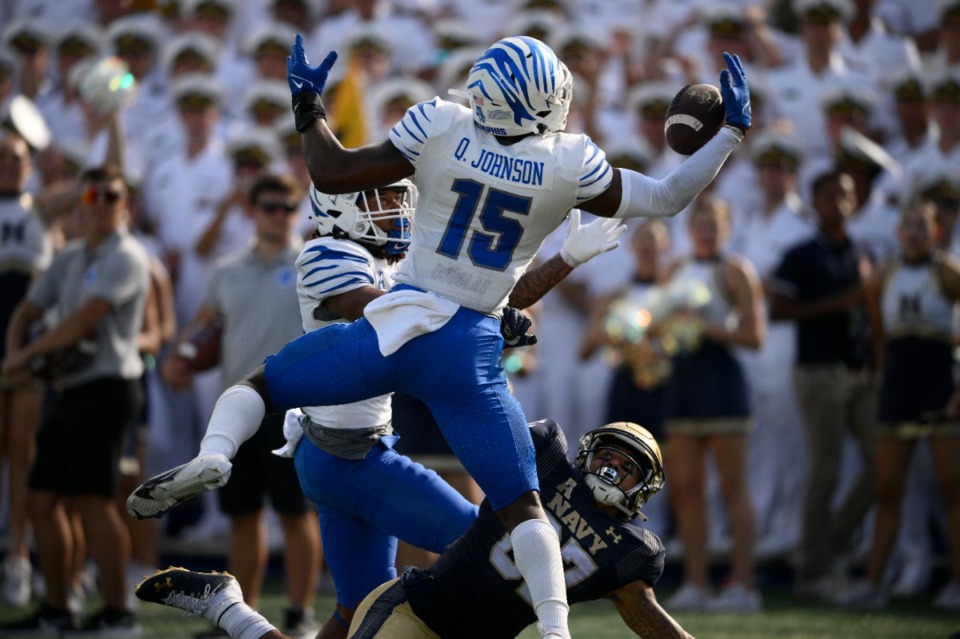 <strong>Memphis defensive back Quindell Johnson (15) breaks up a pass intended for Navy wide receiver Jayden Umbarger (bottom), as Memphis defensive back Ladarian Paulk (back left), looks on during the first half of an NCAA college football game, Saturday, Sept. 10, 2022, in Annapolis, Md. Johnson ended up intercepting the ball on the play.</strong> (Nick Wass/AP)