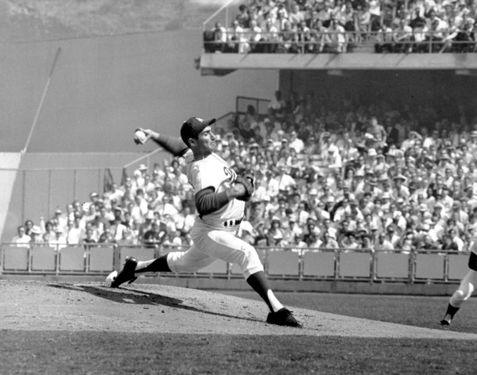 <strong>Left-hander pitcher Sandy Koufax of the Los Angeles Dodgers fired his fast ball, with one leg out front in his long stride, at Dodger Stadium in Los Angeles, on Oct. 11, 1965. The Los Angeles Dodgers of the National League faced the the Minnesota Twins, the American League champions, in the fifth game of the World Series. The Dodgers went on to win the World Series.</strong> (AP file)
