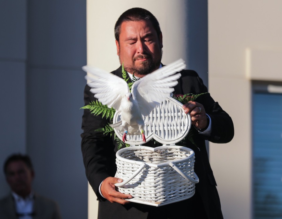 <strong>Wes King, whose mother was killed one year ago today during a mass shooting at a Colliverville Kroger, releases a dove in her honor at Collierville Town Hall Sept. 23, 2022.</strong> (Patrick Lantrip/The Daily Memphian)