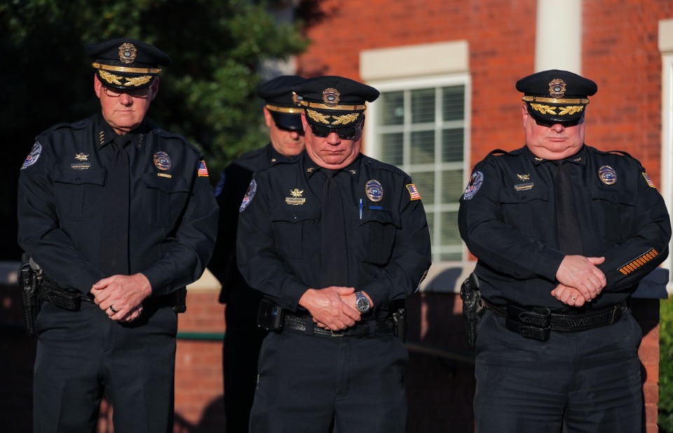 <strong>Law enforcement officers bow their heads in prayer at the vigil at Collierville Town Hall.</strong> (Patrick Lantrip/The Daily Memphian)
