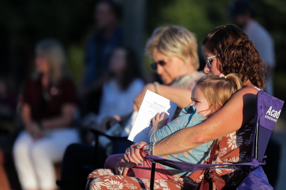 <strong>Stacey Craig and her granddaugter, Paisley Evans, hold a moment of silence at the vigil at Collierville Town Hall on Sept. 23, 2022.</strong> (Patrick Lantrip/The Daily Memphian)