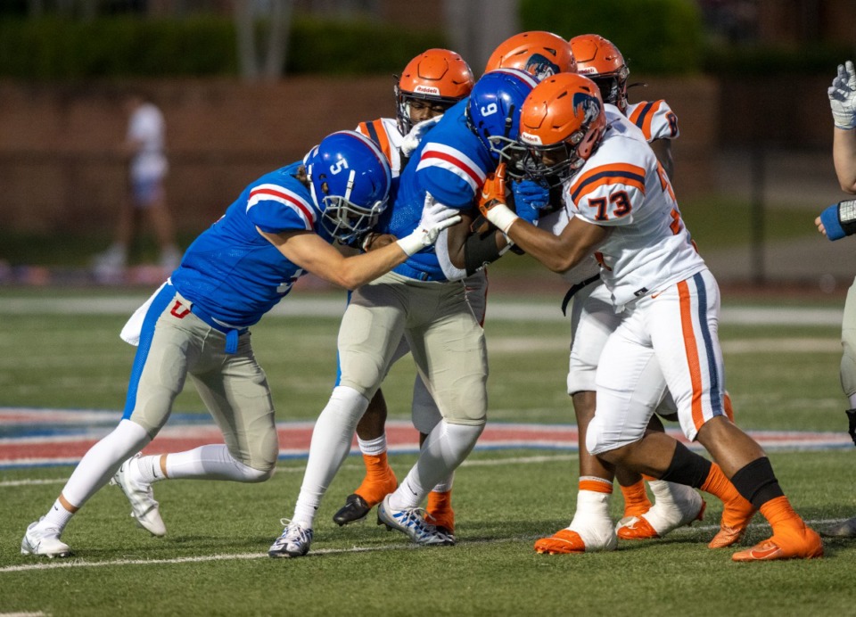 <strong>MUS wide receiver Max Painter tries to help Tee Perry gain a few more yards while Ridgeway's Corby Corbitt tries to stop the running back Friday, Sept. 23, at MUS. MUS defeated Ridgeway 42-7.</strong> (Greg Campbell/Special to The Daily Memphian)