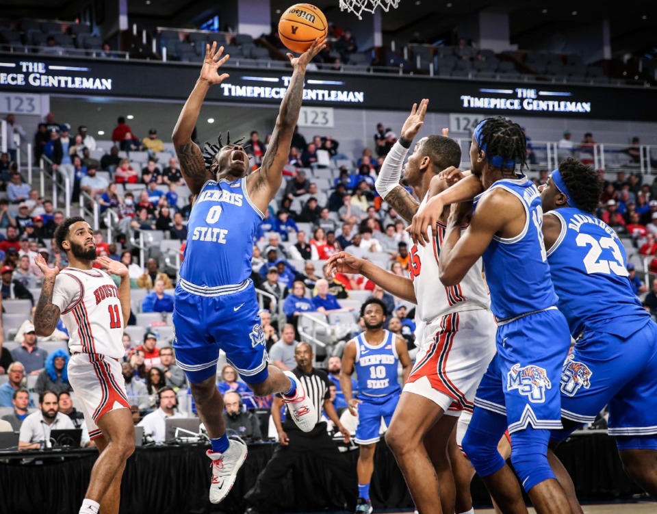 <strong>Tigers guard Earl Timberlake (middle) drives to the basket against the Houston defense during action on Sunday, March 13, 2022 in the AAC Championship game in Fort Worth, Texas.</strong> (Mark Weber/The Daily Memphian)